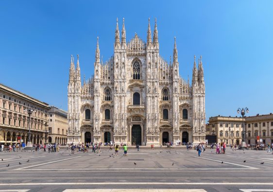 A photo of The Duomo in Milan showing also the piazza in front and buildings on the side