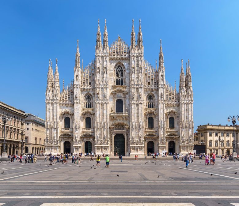 A photo of The Duomo in Milan showing also the piazza in front and buildings on the side
